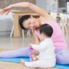 Mother exercising with baby in park
