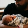 a man holding a baby